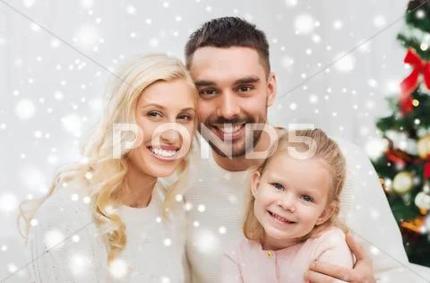 Happy family at home with christmas tree Stock Photos