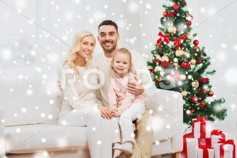 Happy family at home with christmas tree Stock Photos