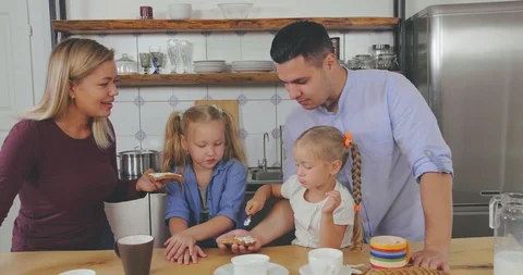 Happy family interacting while having breakfast Stock Footage 116336714