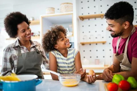 Happy family in the kitchen having fun and cooking together. Healthy food at Stock Photos