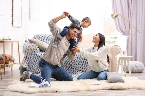 Happy family with little son having fun at home. Winter vacation Stock Photos