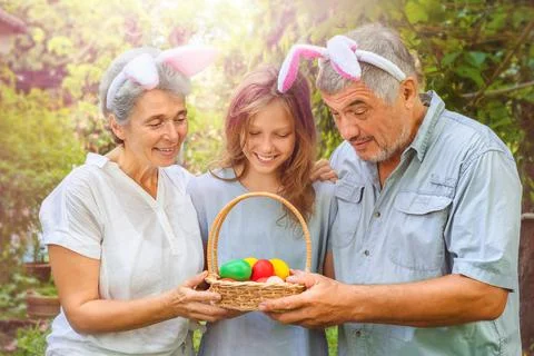 Happy family looking into Easter eggs outdoor Stock Photos