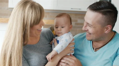 A happy family. Mother, father and son two months. Hold the baby in her arms Stock Footage