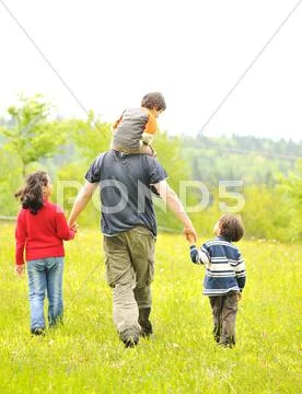 Happy family in nature, father and children walking Stock Photos