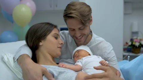 Happy family. Newborn baby resting in mother and father arms. Parents right Stock Footage
