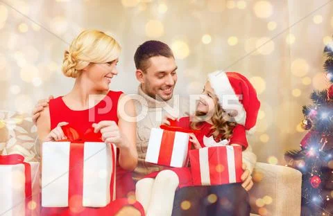 Happy family opening gift boxes Stock Photos