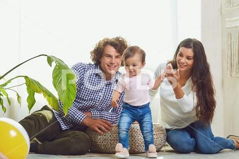 Happy family playing with the child indoors. Stock Photos
