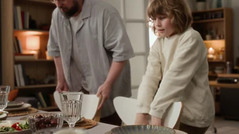 Happy Family Preparing Dining Table for Festive Dinner at Home Stock Footage 340330626