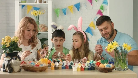 Happy family preparing for Easter and painting Easter eggs Stock Footage 89760905
