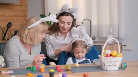 Happy family preparing for Easter. Cute little child girl wearing bunny ears on Stock-Footage 236400381