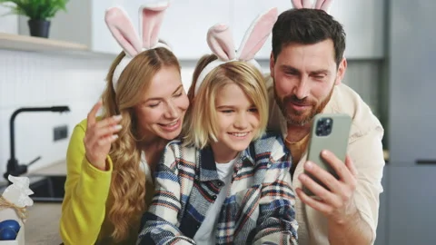A happy family is preparing for the easter holiday using smartphone to video Stock Footage 304383782