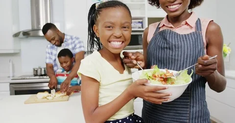 Happy family preparing food in kitchen Stock Footage