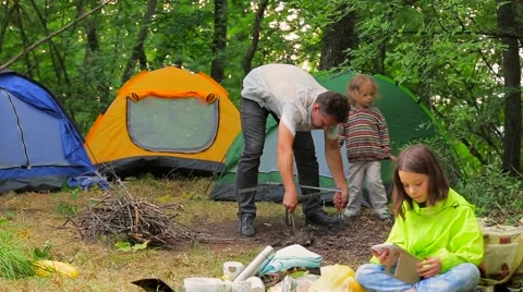 Happy Family Preparing For Picnic At Campsite Stock Footage 59379100