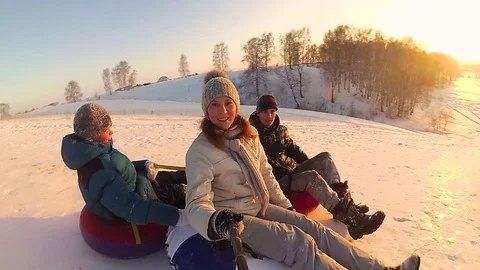 Happy family rides and smiling snowtube on snowy roads.slow motion. snow winter Stock Footage