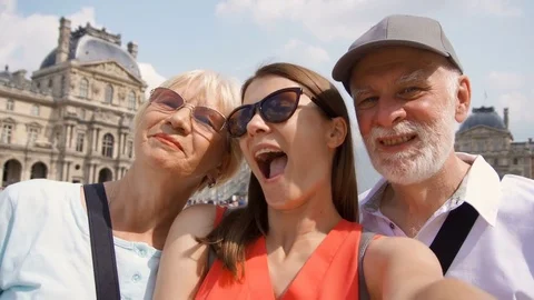 Happy family of senior man and woman with daughter taking selfie on smartphone Stock Footage