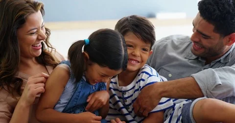 Happy family sitting on sofa and having fun in living room Stock Footage