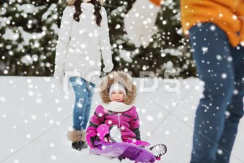 Happy family with sled walking in winter forest Stock Photos