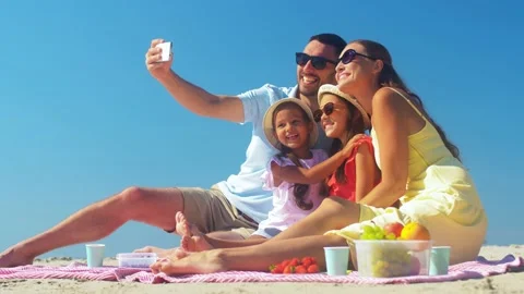 Happy family taking selfie on summer beach Stock Footage 140328286