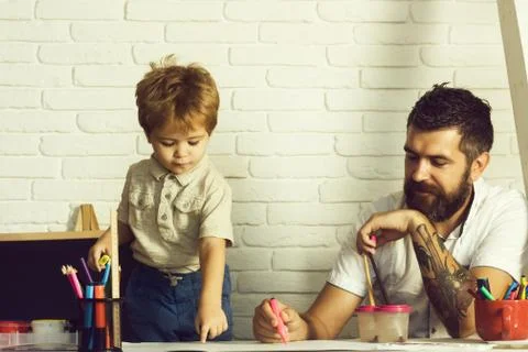 Happy family time, drawing with father on the table, free time and vacations Stock Photos