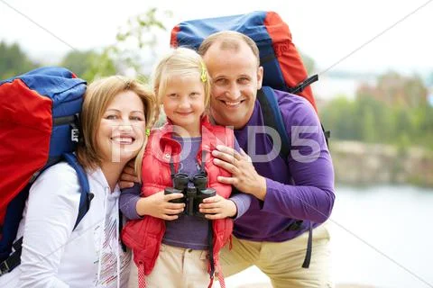 Happy family of travelers smiling at camera Stock Photos