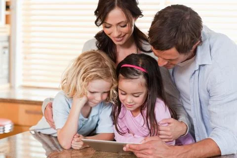 Happy family using a tablet computer together 스톡 사진