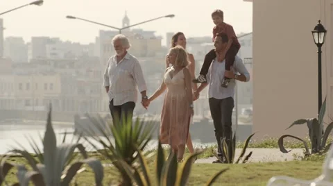 Happy family walking and relaxing in city park Stock Footage