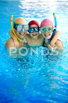 Happy family in water wearing scuba mask looking at camera Stock Photos
