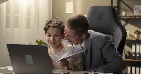 Happy father and son having fun sitting at the table. Young businessman and kid Stock Footage 275541439