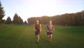 The happy father and a son running in the beautiful park. slow motion 4k or 4k+ Resolution