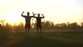 The happy father and a son showing muscles on the sunset background. slow motion 4k or 4k+ Resolution
