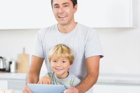 Happy father and son using tablet computer 스톡 사진