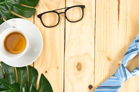 Happy Father Day background concept with blue necktie, leaf, glasses and cup  Stock Photos