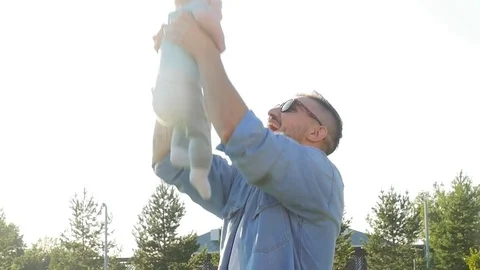 Happy father having fun throws up in the air child at sunset, family, travel Stock Footage 78697469