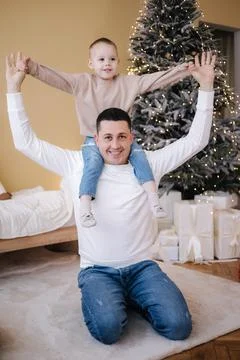 Happy father with his son playing home during winter holidays. Christmas is Stock Photos