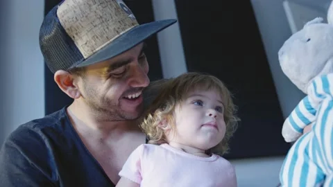 Happy father playing with little daughter and stuffed animal Stock Footage 143292653