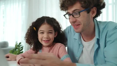 Happy father pointing at laptop screen while explain prompt to child. Pedagogy. Stock Footage 295467540