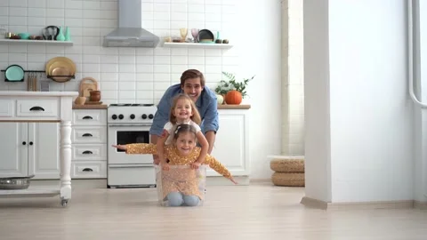 Happy father run push box with little cute children daughters ride inside Stock Footage 142579895