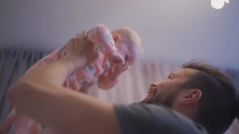 Happy father throwing up his son at home in living room Stock Footage 167806985