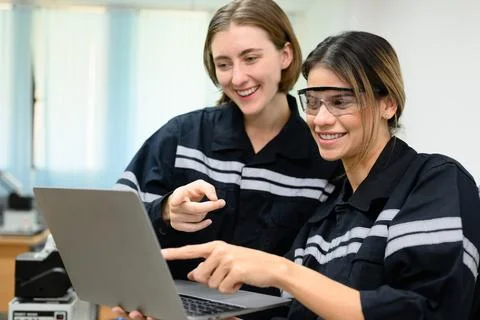 Happy female engineers team using laptop checking and operating 写真素材