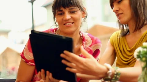 Happy female friends with tablet computer in restaurant, steadycam shot Stock Footage 8675596