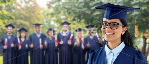 Happy female graduate student in mortarboard Stock Photos