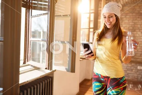 Happy female looking on cell phone indoor Stock Photos
