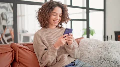 Happy female messaging in flat Stock Footage 207489810