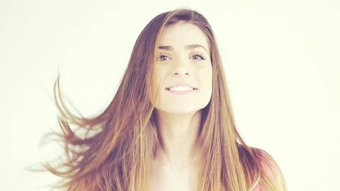 Happy female model moving long silky hair Stock Footage 74132626
