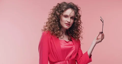 Happy female Model posing on Camera at Studio while demonstrating Trendy pink Stock Footage 126157107