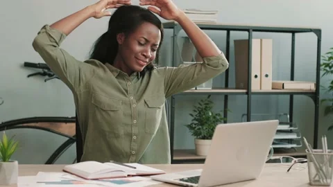 Happy female office worker dancing and singing while sitting at her desk Stock Footage 148243286