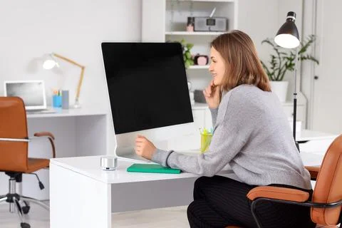 Happy female programmer with computer working in office Stock Photos