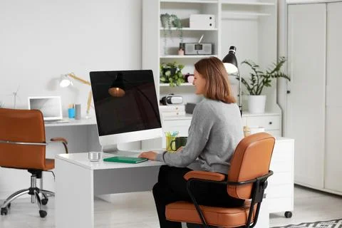 Happy female programmer with computer working in office 스톡 사진