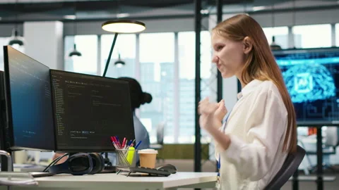 Happy female programmer dancing on office desk chair Vídeos de archivo 313166632