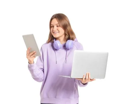 Happy female programmer with laptop, tablet and headphones isolated on white  库存照片